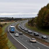 Police have arrested two teenagers after reports of projectiles and rocks being thrown from a bridge onto a motorway