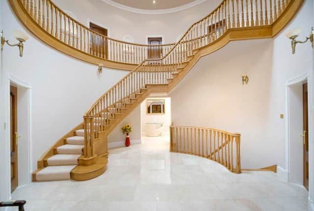 The grand staircase looks like something from a film (Image: Rightmove)