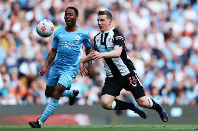 Raheem Sterling of Manchester City challenges Matt Targett of Newcastle United during the Premier League match between Manchester City and Newcastle United at Etihad Stadium on May 08, 2022 in Manchester, England.