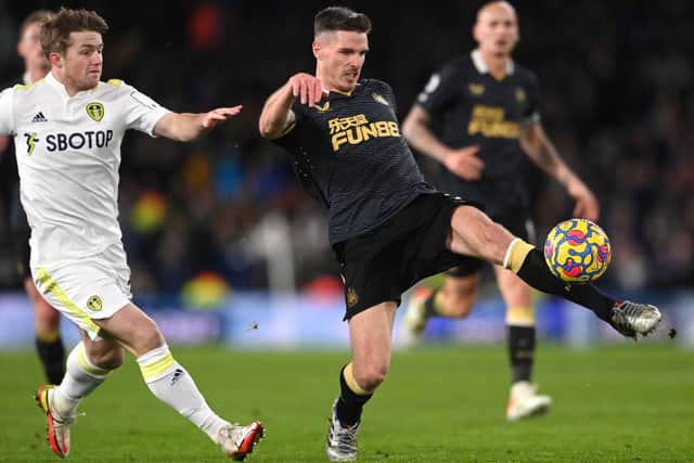 Newcastle defender Ciaran Clark (r) clears under pressure from Joe Gelhardt of Leeds during the Premier League match between Leeds United and Newcastle United at Elland Road on January 22, 2022 in Leeds, England.