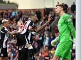 Callum Wilson of Newcastle United celebrates with teammates after scoring their side's first goal from the penalty spot during the Premier League match between Burnley and Newcastle United at Turf Moor on May 22, 2022 in Burnley, England. (Photo by Gareth Copley/Getty Images)