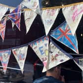 Community bunting in a shop window
