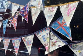 Community bunting in a shop window