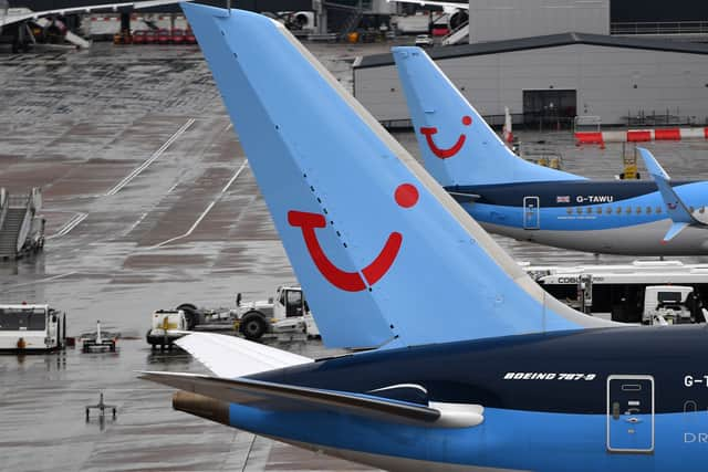 A pilot helped load luggage onto a plane at Manchester Airport.