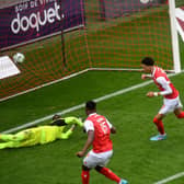 Reims French forward Hugo Ekitike (C) shoot and scores during the French L1 football match Reims and Bordeaux at the Auguste Delaune Stadium in Reims on February 6, 2022.