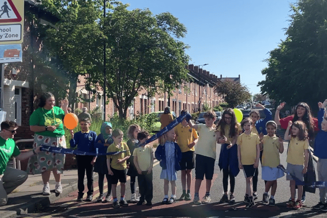 Children cut the ribbon to celebrate th oepning of the scheme