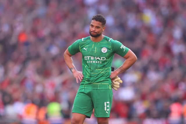 Zak Steffen of Manchester City reacts following defeat in The Emirates FA Cup Semi-Final match between Manchester City and Liverpool at Wembley Stadium on April 16, 2022 in London, England. 
