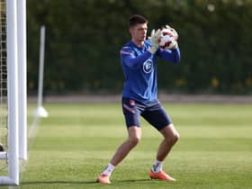 Goalkeeper Nick Pope of England makes a save during a training session at Tottenham Hotspur Training Centre on March 28, 2022 in Enfield, England.