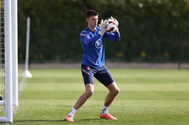 Goalkeeper Nick Pope of England makes a save during a training session at Tottenham Hotspur Training Centre on March 28, 2022 in Enfield, England.