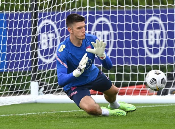 <p>Nick Pope of England dives for the ball during a training session at Tottenham Hotspur Training Centre on September 04, 2021 in Enfield, England. </p>