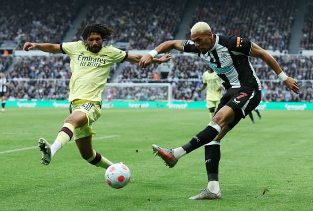 Joelinton of Newcastle United shoots under pressure from Mohamed Elneny of Arsenal during the Premier League match between Newcastle United and Arsenal at St. James Park on May 16, 2022 in Newcastle upon Tyne, England.