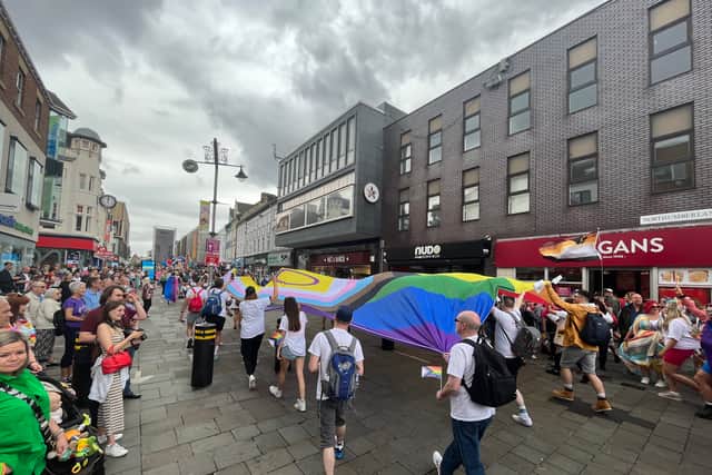 A huge Pride flag sails down Northumberland Street.