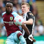 Maxwel Cornet of Burnley is challenged by Matt Targett of Newcastle United (Photo by Jan Kruger/Getty Images)