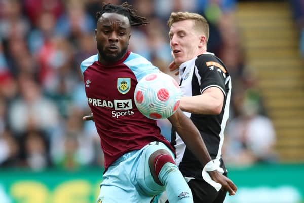 Maxwel Cornet of Burnley is challenged by Matt Targett of Newcastle United (Photo by Jan Kruger/Getty Images)