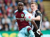 Maxwel Cornet of Burnley is challenged by Matt Targett of Newcastle United (Photo by Jan Kruger/Getty Images)