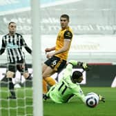 Miguel Almiron of Newcastle United watches his shot hit the post as Conor Coady of Wolverhampton Wanderers looks on during the Premier League match between Newcastle United and Wolverhampton Wanderers (Photo by Owen Humphreys - Pool/Getty Images)