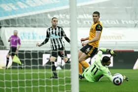 Miguel Almiron of Newcastle United watches his shot hit the post as Conor Coady of Wolverhampton Wanderers looks on during the Premier League match between Newcastle United and Wolverhampton Wanderers (Photo by Owen Humphreys - Pool/Getty Images)