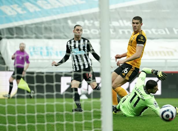 <p>Miguel Almiron of Newcastle United watches his shot hit the post as Conor Coady of Wolverhampton Wanderers looks on during the Premier League match between Newcastle United and Wolverhampton Wanderers (Photo by Owen Humphreys - Pool/Getty Images)</p>