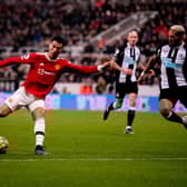 Manchester United star Cristiano Ronaldo takes on Newcastle United midfielder Joelinton (Photo by Ash Donelon/Manchester United via Getty Images)