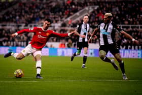 Manchester United star Cristiano Ronaldo takes on Newcastle United midfielder Joelinton (Photo by Ash Donelon/Manchester United via Getty Images)