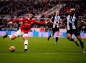 Manchester United star Cristiano Ronaldo takes on Newcastle United midfielder Joelinton (Photo by Ash Donelon/Manchester United via Getty Images)