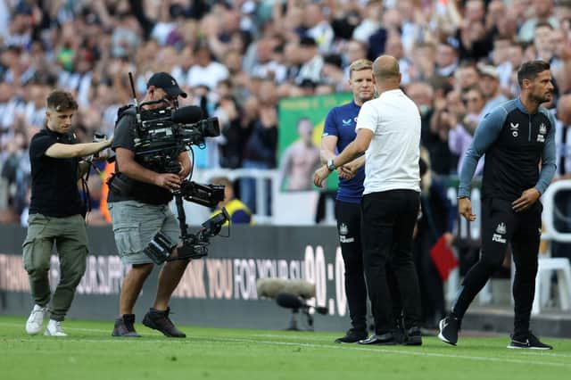 Eddie Howe, Manager of Newcastle United and Pep Guardiola, Manager of Manchester City interact after the final whistle of the Premier League match between Newcastle United and Manchester City at St. James Park on August 21, 2022 in Newcastle upon Tyne, England.