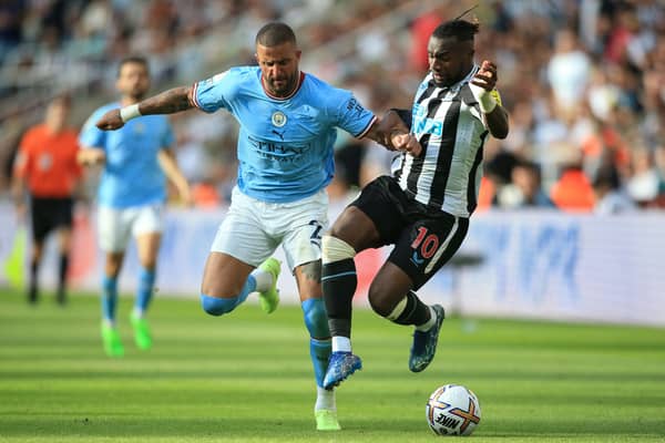 Manchester City defender Kyle Walker fights for the ball with Newcastle United’s winger Allan Saint-Maximin (Photo by LINDSEY PARNABY/AFP via Getty Images)