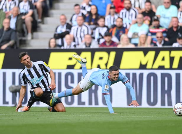 <p>Newcastle United defender Fabian Schar challenges Manchester City’s Phil Foden. (Photo by Stu Forster/Getty Images)</p>