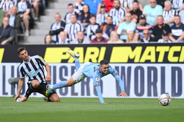Newcastle United defender Fabian Schar challenges Manchester City’s Phil Foden. (Photo by Stu Forster/Getty Images)