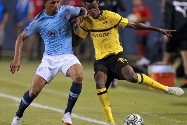 Manchester City’s Jason Denayer vies for the ball with Borussia Dortmund’s Alexander Isak (Photo by JIM YOUNG / AFP)  