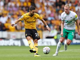 Joao Moutinho of Wolverhampton Wanderers is put under pressure by Sean Longstaff of Newcastle United  (Photo by David Rogers/Getty Images)