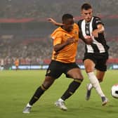 Kelland Watts of Newcastle United in action with Niall Ennis of Wolverhampton Wanderers during the Premier League Asia Trophy 2019 match  (Photo by Lintao Zhang/Getty Images for Premier League)