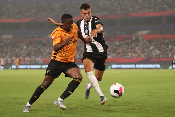 Kelland Watts of Newcastle United in action with Niall Ennis of Wolverhampton Wanderers during the Premier League Asia Trophy 2019 match  (Photo by Lintao Zhang/Getty Images for Premier League)