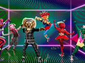 Five Masked Dancers - Sea Slug, Pig, Pearly King, Onomatopoeia, Tomato Sauce and Cactus - pose on an electric green soundstage (Credit: ITV)