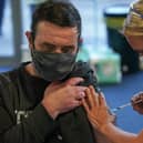 A man receives his Covid-19 booster jab (Photo by Ian Forsyth/Getty Images).