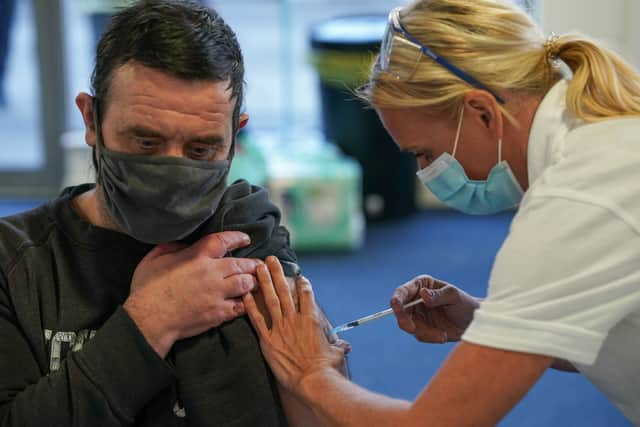 A man receives his Covid-19 booster jab (Photo by Ian Forsyth/Getty Images).