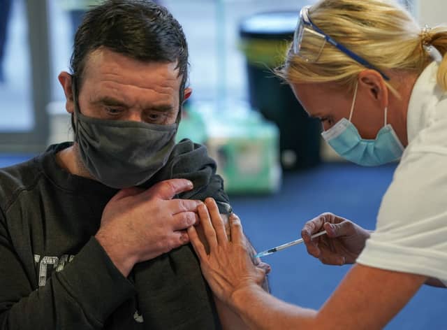 A man receives his Covid-19 booster jab (Photo by Ian Forsyth/Getty Images).