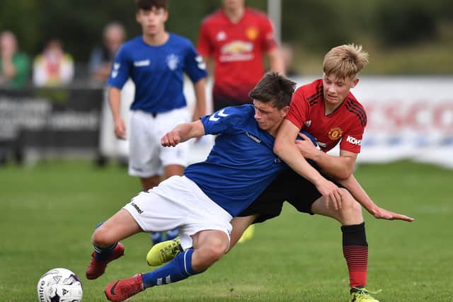 George Walters of Manchester United and Cole McKinnon of Rangers compete for the ball during the Super Cup NI football tournament junior section game between Manchester United and Rangers on July 24, 2018 in Ballymena, Northern Ireland.