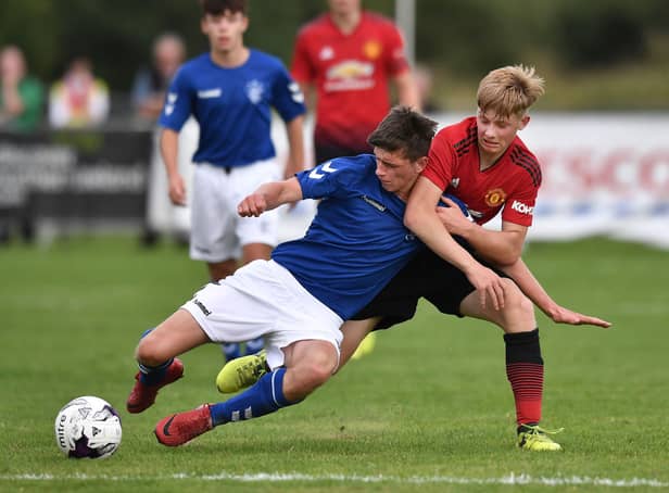 <p>George Walters of Manchester United and Cole McKinnon of Rangers compete for the ball during the Super Cup NI football tournament junior section game between Manchester United and Rangers on July 24, 2018 in Ballymena, Northern Ireland. </p>