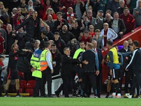 The Liverpool bench celebrate after the winning goal during the Premier League match against Newcastle United (Photo by John Powell/Liverpool FC via Getty Images)