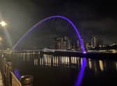 The Gateshead Millennium Bridge shines purple