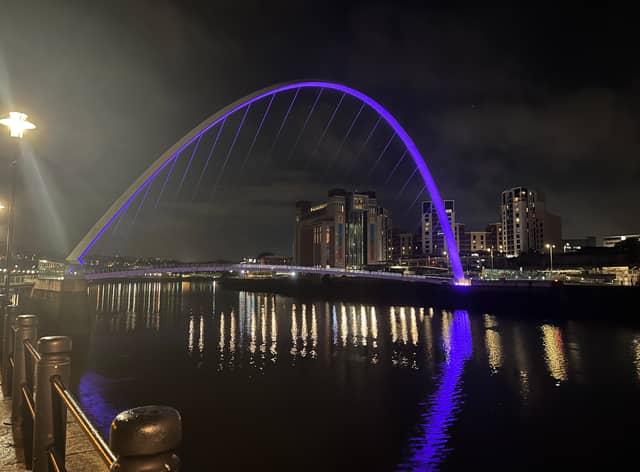 The Gateshead Millennium Bridge shines purple