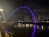 The Gateshead Millennium Bridge shines purple