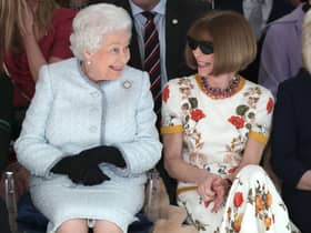 LONDON, ENGLAND - FEBRUARY 20:  Queen Elizabeth II sits next to Anna Wintour as they view Richard Quinn’s runway show before presenting him with the inaugural Queen Elizabeth II Award for British Design as she visits London Fashion Week’s BFC Show Space on February 20, 2018 in London, United Kingdom. (Photo by Yui Mok - Pool/Getty Images)