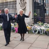 King Charles and Queen Consort Camilla wave to the crowd upon their arrival Buckingham Palace in London. (Getty Images)