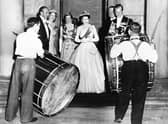 John Warden Brooke, 2nd Viscount Brookeborough (L), Queen Elizabeth II (C) and her husband Prince Philip, Duke of Edinburgh listen to drummers, on July 3, 1953 during their official visit to Northern Ireland.