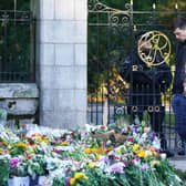 Members of the public look at floral tributes at Balmoral in Scotland following the death of Queen Elizabeth II on Thursday. Picture date: Saturday September 10, 2022. (Photo: PA)