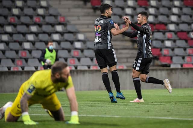Former Lyon teammates Lucas Paqueta and Bruno Guimaraes. (Photo by NICOLAS TUCAT/AFP via Getty Images)
