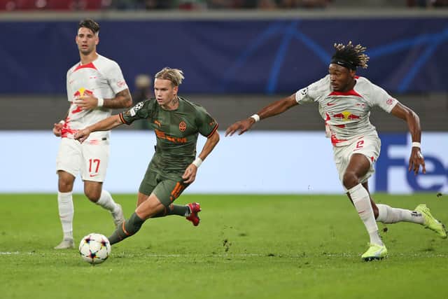 Mykhaylo Mudryk of Shakhtar Donetsk is challenged by Mohamed Simakan of RB Leipzig during the UEFA Champions League group F match between RB Leipzig and Shakhtar Donetsk at Red Bull Arena on September 06, 2022 in Leipzig, Germany. 