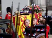 The Bearer Party transfer the coffin of Queen Elizabeth II, draped in the Royal Standard